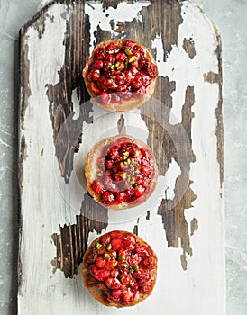 Three homemade mini-cheesecake with wild strawberries