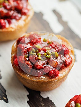 Three homemade mini-cheesecake with wild strawberries