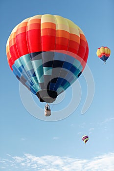 Three hot air balloons at a balloon rally.