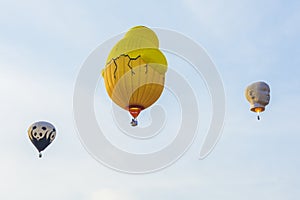 Three hot air balloons in blue sky