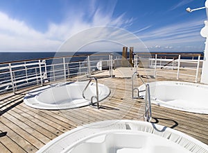 Three hot tub on the deck of a cruise