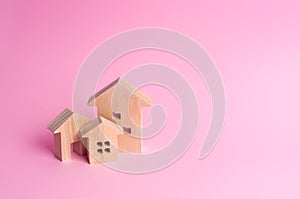 Three houses on a pink background. Buying and selling of real