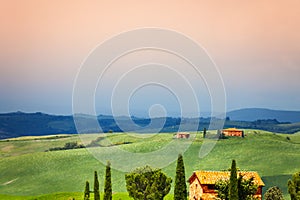 Three houses in Tuscany landscape, Italy