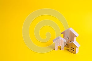 Three houses on a yellow background. Buying and selling of real