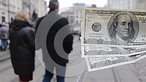 Three hundred-dollar bills on blurred background