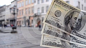 Three hundred dollar bills on blurred background of european