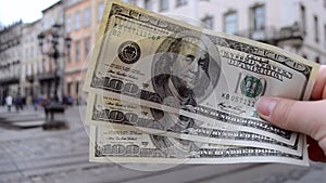 Three hundred dollar bills on blurred background of european