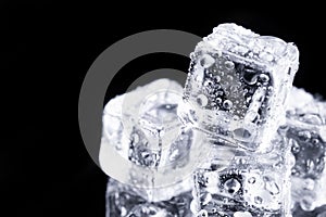 Three ice cubes on black background