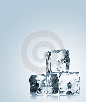 Three ice cubes stacked over blue gradient background