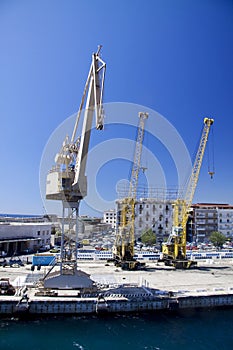 Three industrial cranes