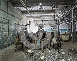 Three industrial machines left forgotten in abandoned factory