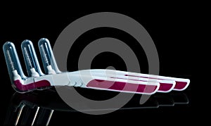 Three interdental brush with cover isolated on dark background with copy space.