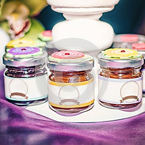 Three jar of jam and honey on the table