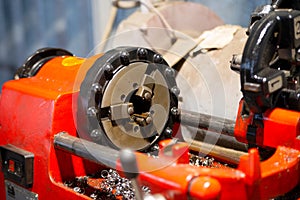 Three-jaw lathe chuck in red threading machine