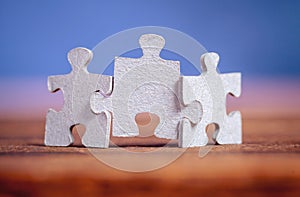 Three jigsaw puzzle pieces on a table