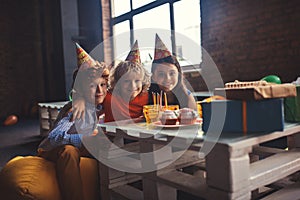 Three kids celebrating bday and feeling joyful