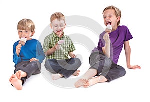 Three kids eating ice lolly