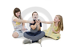 Three kids fighting for video games