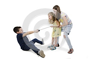 Three kids fighting for video games photo