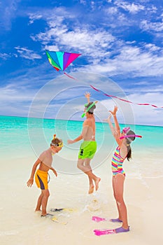 Three kids playing on beach