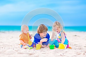 Three kids playing on a beach