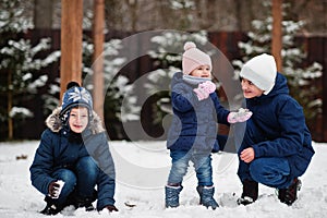Three kids playing in winter day. Brothers with yongest sister