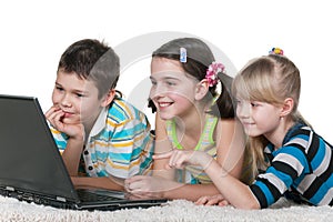 Three kids reading internet information