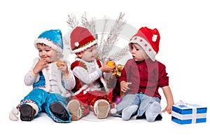 Three kids in Santa hats