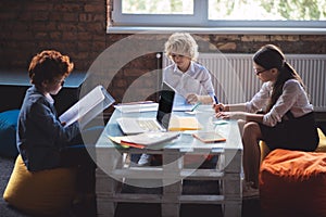 Three kids studying together and looking involved