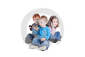 Three kids using mobile phones