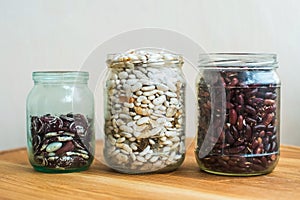 Three kind of sorts of beans in glass jars