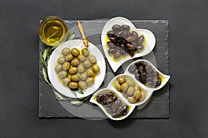 Three kinds of selected olives and olive oil.