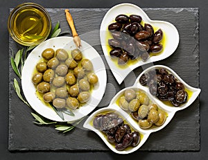 Three kinds of selected olives and olive oil.