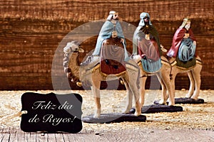 three kings and text feliz dia de reyes, happy epiphany in spanish