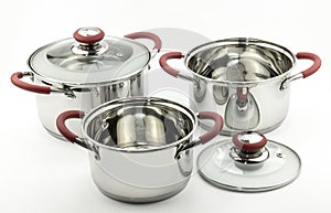 Three kitchen cooking pots with red handles and glass lids