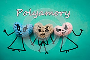 Three knitted hearts on blue background and the text - polyamory