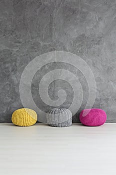 Three knitted poufs photo