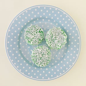 Three Kuih Lopes on a blue round plate. square photo image.