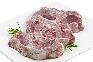 Three lamb chops on a white plate