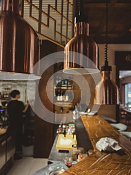 Three lamps above the serving table in a restaurant