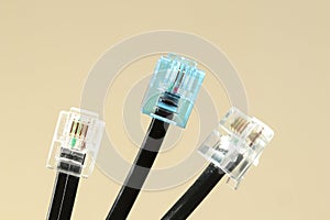 Three lan cables with blue and white rj-45 connector on white