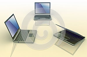 Three laptops over colored background