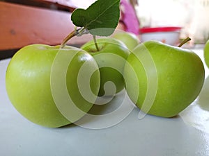 Three large green apples