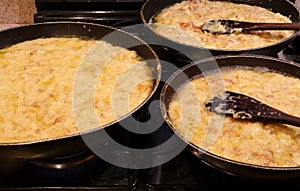 Three large pots with FRICO with aged cheese and baked potatoes
