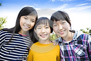 Three laughing attractive teens girlfriends