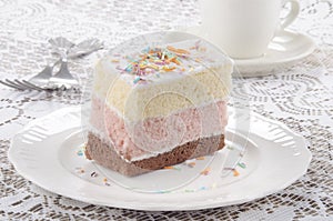 Three layer cake with coloured sprinkle