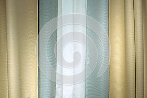 Three-layer curtains in yellow, green fabric and white tulle