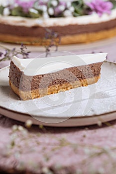 Three layered chocolate cheesecake decorated in festive mood