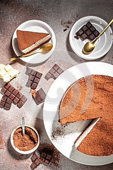 Three layered chocolate mousse cake on a light background. vertical image. top view. place for text