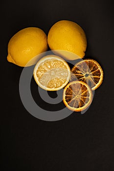 Three lemons with dried orange.